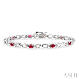 4x3 MM Oval Cut Ruby and 1/10 ctw Single Cut Diamond Bracelet in 10K White Gold