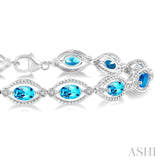 1/10 ctw Round Cut Diamond & 6x4 MM Oval Cut Blue Topaz Semi Precious Bracelet in Sterling Silver