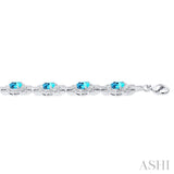 1/10 ctw Oval Shape 7x5 MM Blue Topaz and Round Cut Diamond Semi Precious Bracelet in Sterling Silver