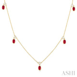 1/8 ctw Round Cut Diamonds and 5X3MM Oval Shape Ruby Precious Station Necklace in 10K Yellow Gold