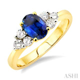 7x5mm Oval Cut Sapphire and 1/3 Ctw Round Cut Diamond Ring in 14K Yellow Gold